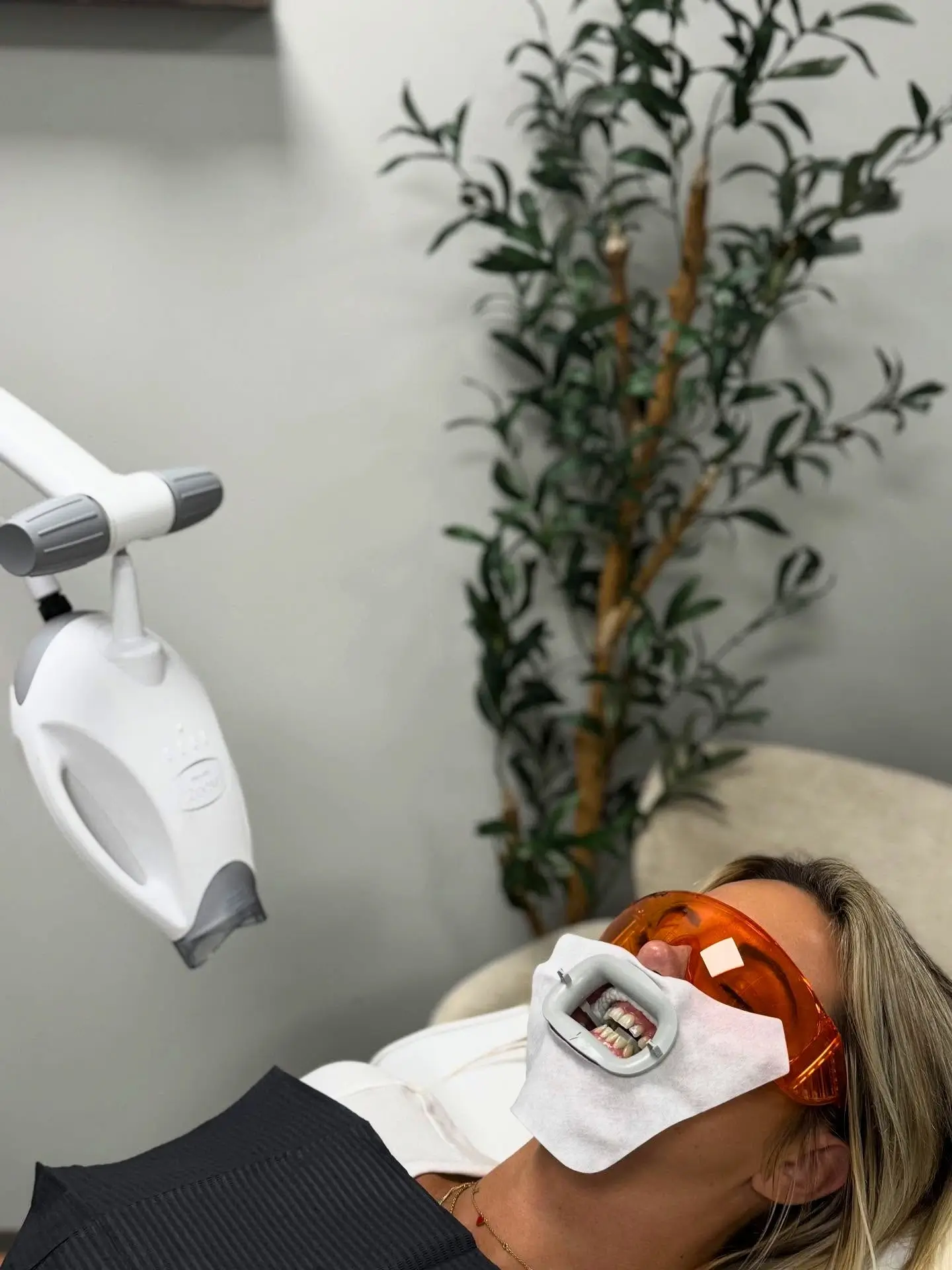 Client relaxing during a teeth whitening treatment